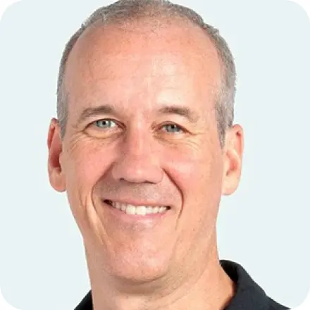 Smiling man in black polo