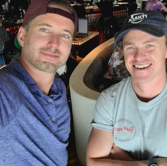 Two men in baseball caps taking a selfie