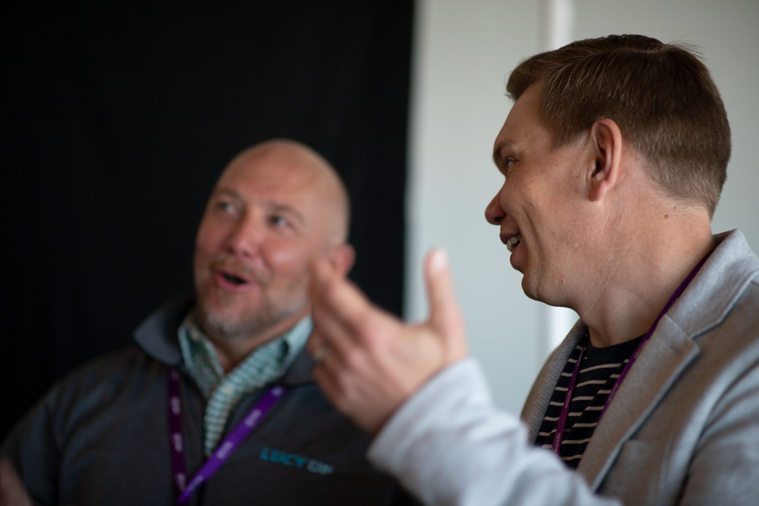 Two men laughing during a conversation