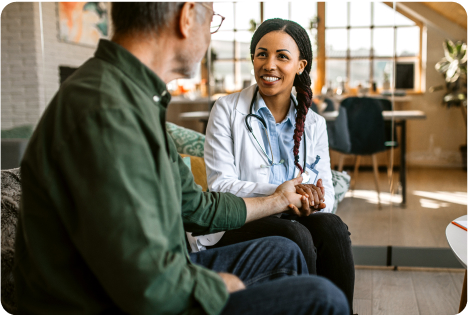 White man, Black woman with long braids shake hands